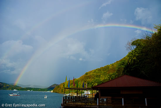 A rainbow appears after a tropical rain that blocked the view of the bay in Anilao